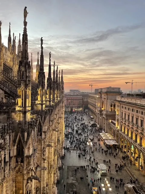 Spires of the Milan Duomo glowing at sunset