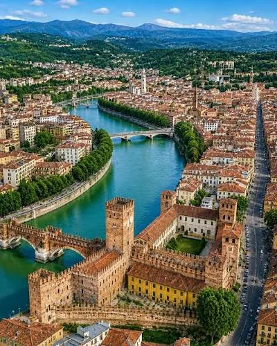 Aerial view of Verona with the Adige river curving past the medieval Castelvecchio fortress